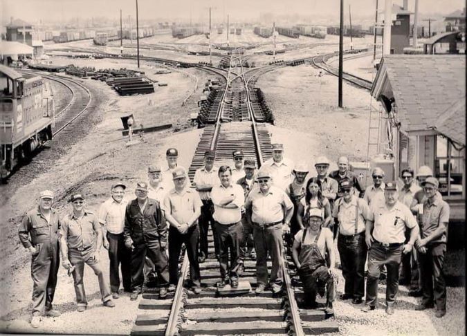 Richard Leahy, on the left rail with his arms crossed, and crew in Galesburg 
